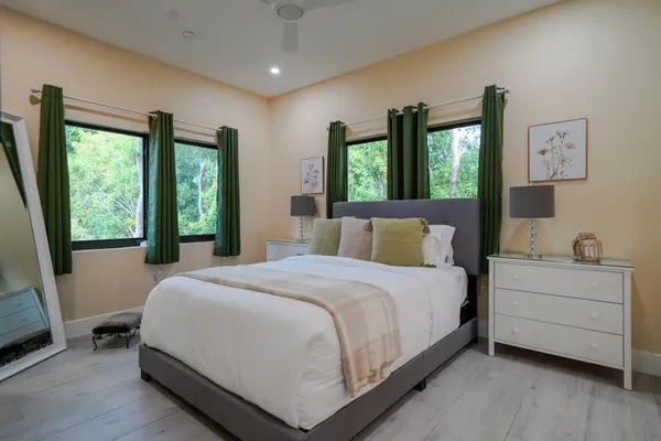 a bedroom with a bed and a large window