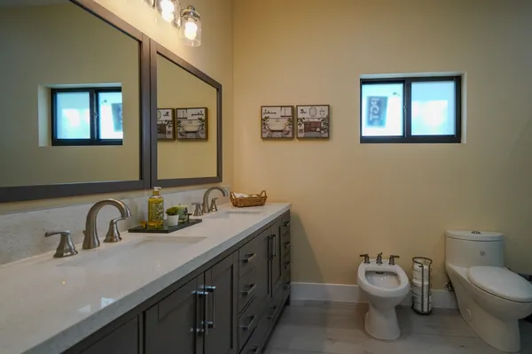 a bathroom with a toilet sink and mirror