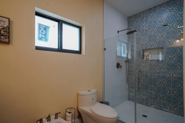 a bathroom with a toilet and a shower