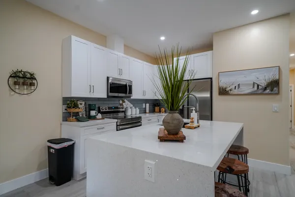 a kitchen with a sink a stove and cabinets
