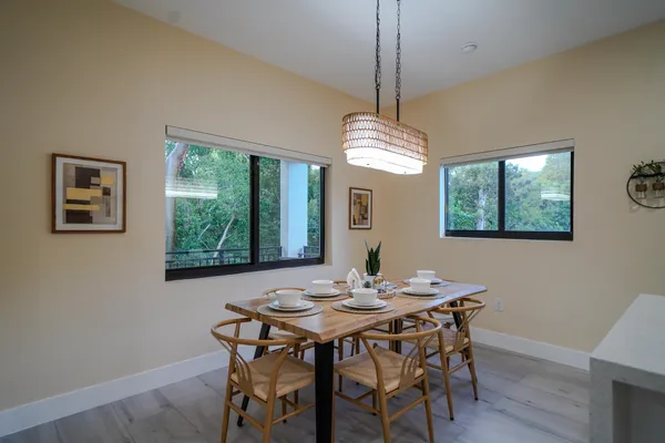 a view of a dining room with furniture window and wooden floor