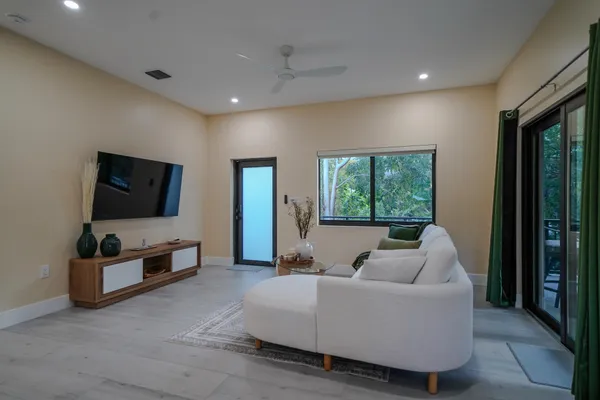 a living room with furniture and a flat screen tv