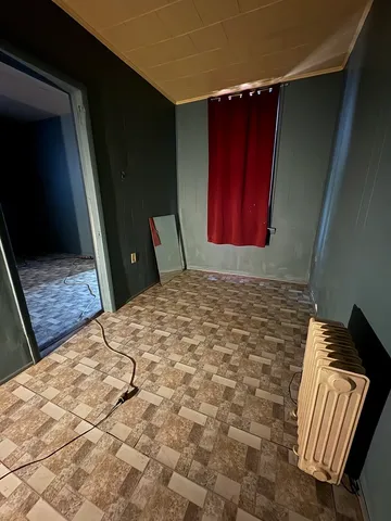 a bedroom with a bed and mirror