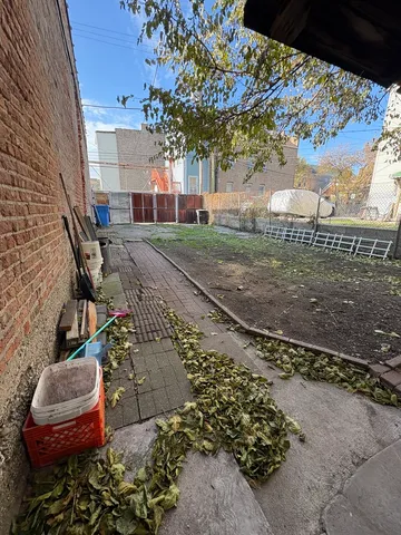 a view of a yard with plants and trees