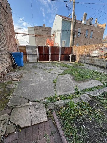 a view of a backyard with sitting area