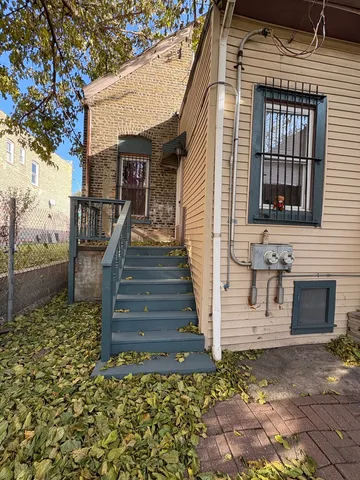 a view of a house with a patio and a yard