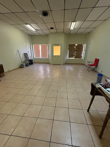 a room with gym equipment and windows