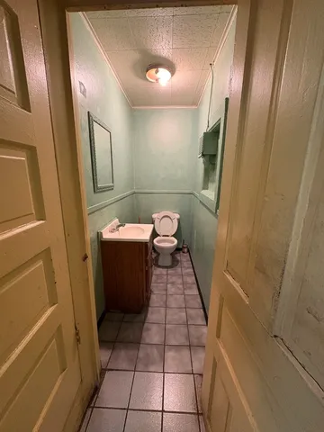 a bathroom with a sink a toilet a mirror and vanity