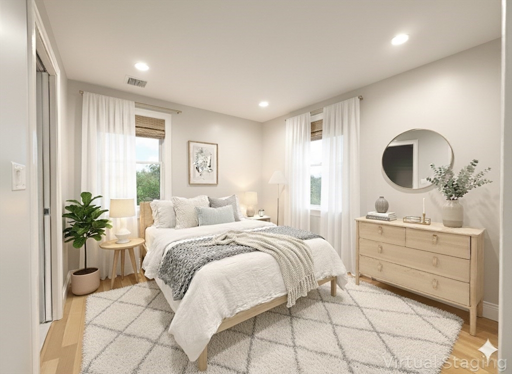 29 Goldsmith Street, Unit 3 Boston, MA 02130 - Photo 5 of 21 a bedroom with a large bed and a potted plant
