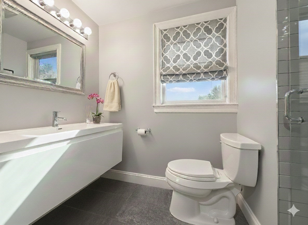 29 Goldsmith Street, Unit 3 Boston, MA 02130 - Photo 8 of 21 a bathroom with a toilet sink and mirror