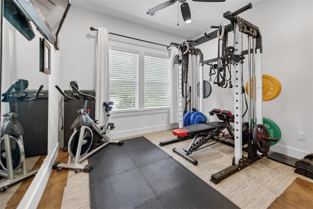 6371 Mill Run Road Athens, TX 75751 - Photo 19 of 40 Dedicated fitness area with ample natural light from two windows, featuring a ceiling fan, and a neutral color palette