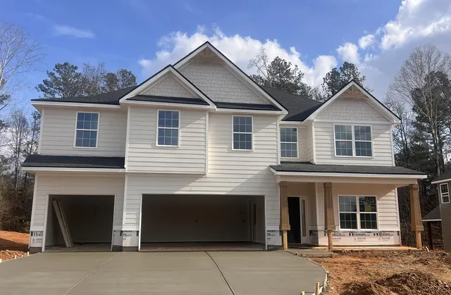a front view of a house with a yard and garage