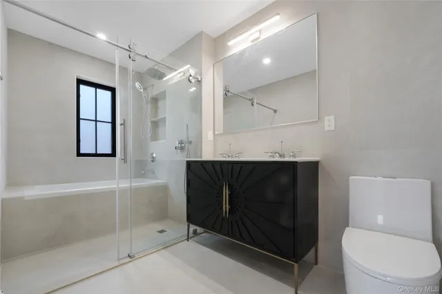a bathroom with a toilet sink and shower