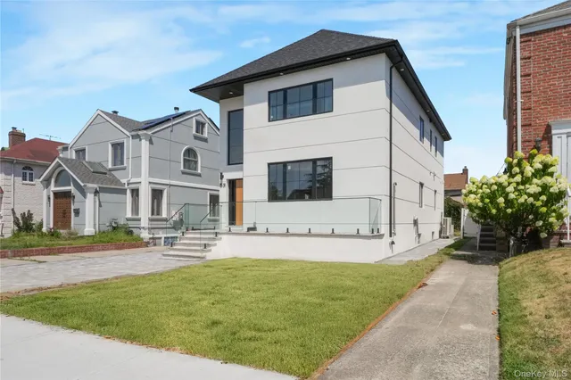 a front view of a house with garage and yard