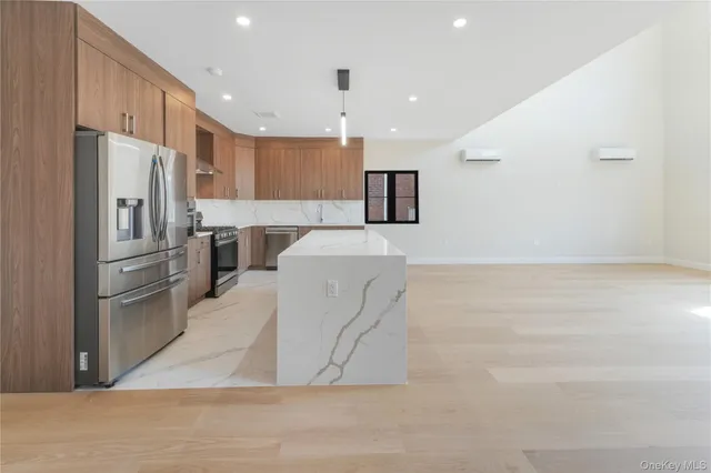 a kitchen with stainless steel appliances a refrigerator sink and microwave