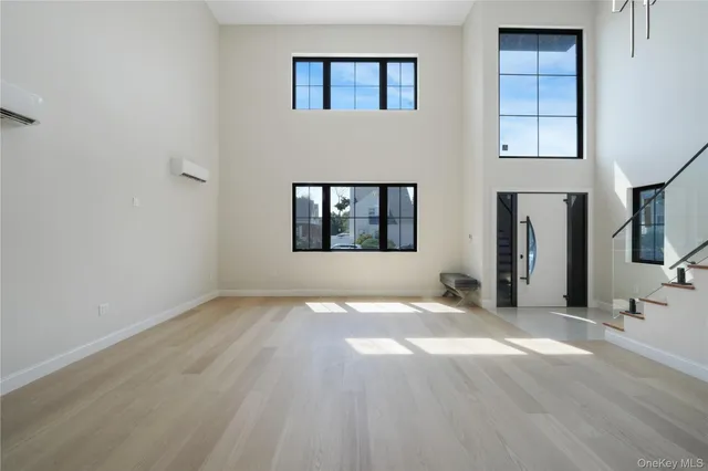 an empty room with windows and closet