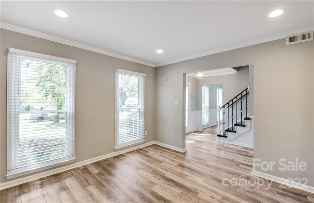 10500 Fairway Ridge Road Charlotte, NC 28277 - Photo 7 of 34 a view of a hallway to an empty room with wooden floor and a window