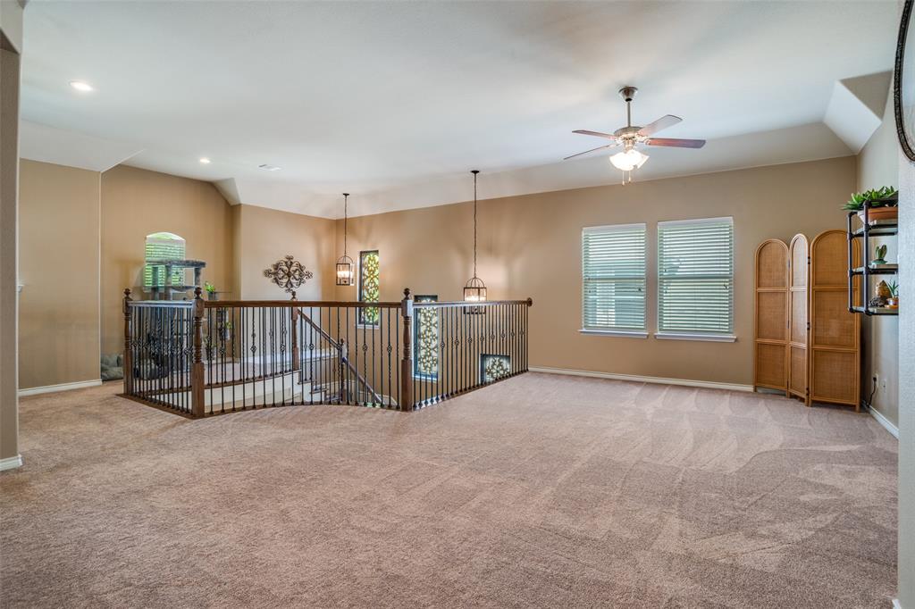 10109 Petrified Tree Lane McKinney, TX 75072 - Photo 11 of 27 a view of a livingroom with a furniture ceiling fan and windows