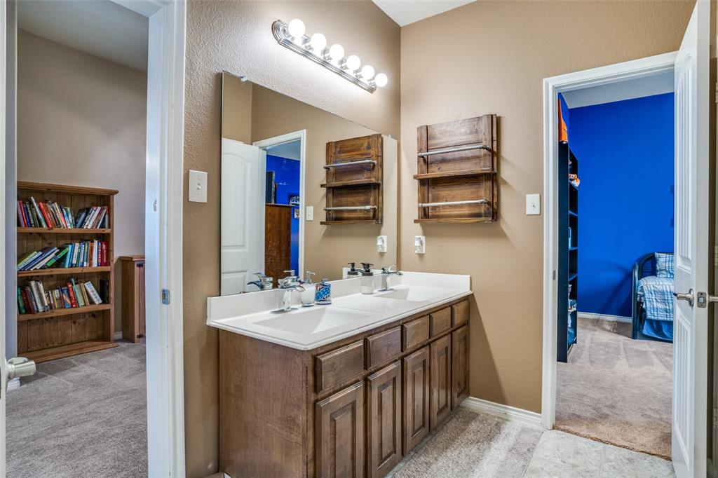 10109 Petrified Tree Lane McKinney, TX 75072 - Photo 14 of 27 a bathroom with a sink a toilet and a mirror
