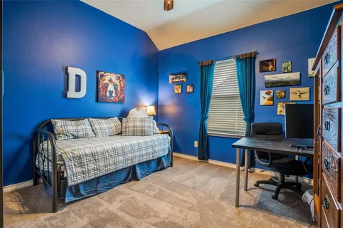 a bedroom with a bed and a desk