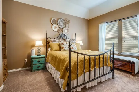 a bed room with a bed and a chandelier