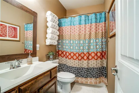 a bathroom with a sink toilet and a shower