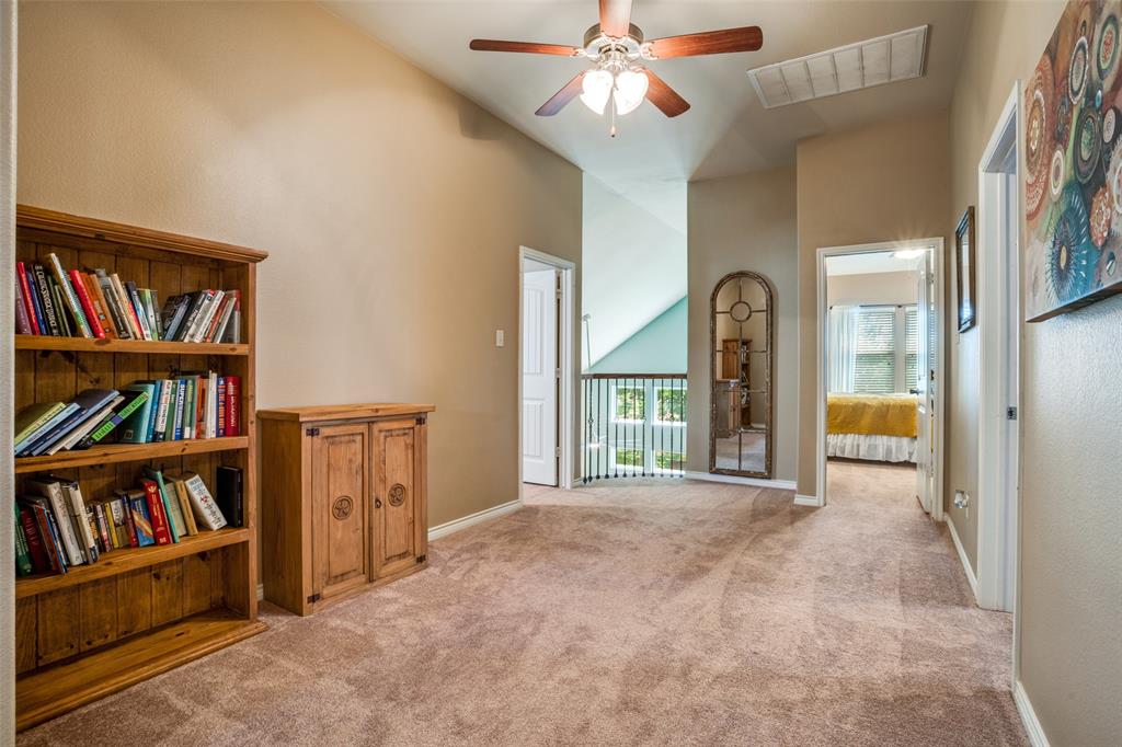 10109 Petrified Tree Lane McKinney, TX 75072 - Photo 19 of 27 a view of an empty room with furniture and a book shelf