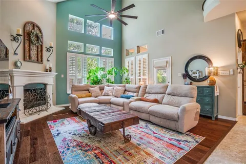 a living room with furniture a rug and a fireplace
