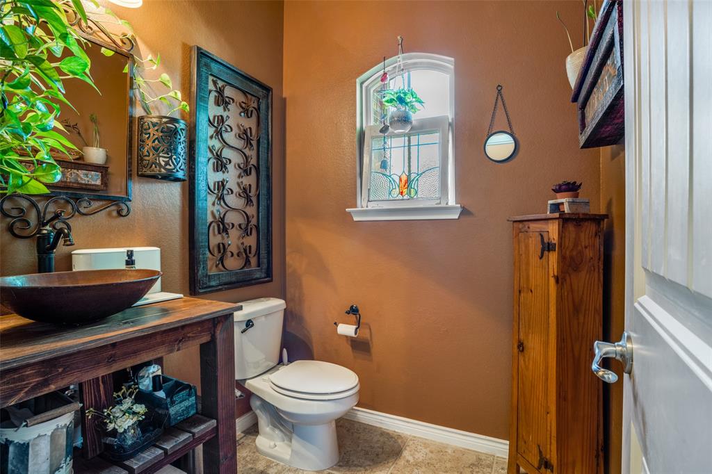 10109 Petrified Tree Lane McKinney, TX 75072 - Photo 8 of 27 a bathroom with a toilet a sink and a window