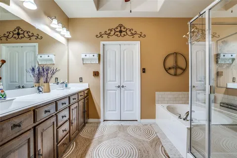 a bathroom with a sink a mirror and a shower