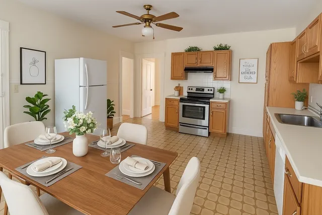 a kitchen with stainless steel appliances a dining table and chairs