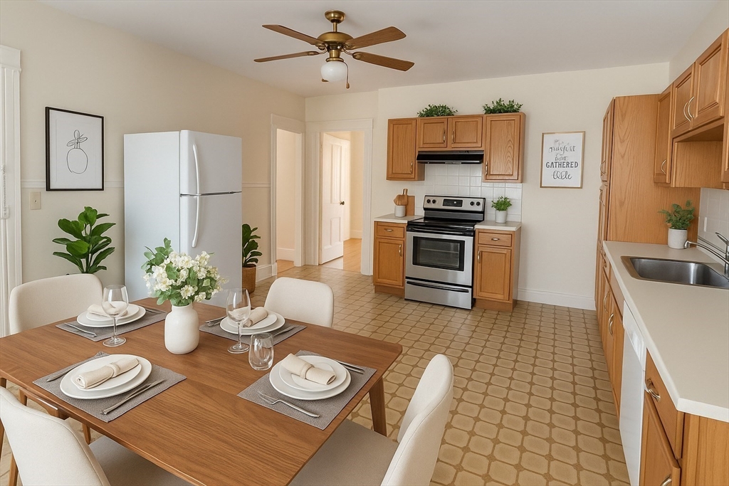 a kitchen with stainless steel appliances a dining table and chairs