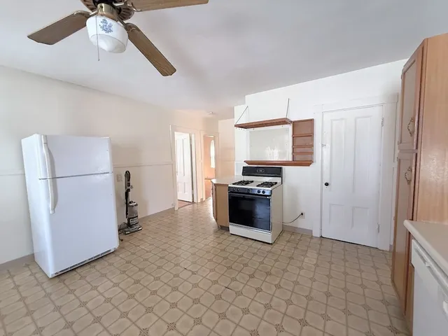 a kitchen with stainless steel appliances a refrigerator and a stove top oven