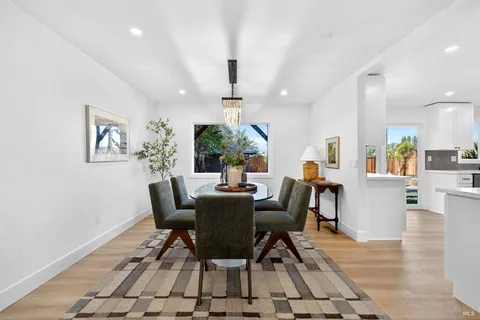 a view of a dining room with furniture and chandelier