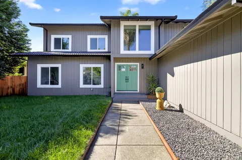 a view of a hallway with entryway wooden floor and front door
