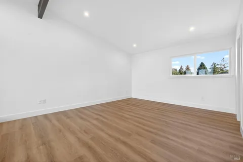 a view of a backyard with plants and patio