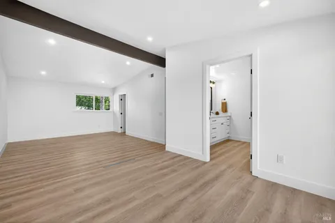 a view of a brick house with a yard and plants next to road