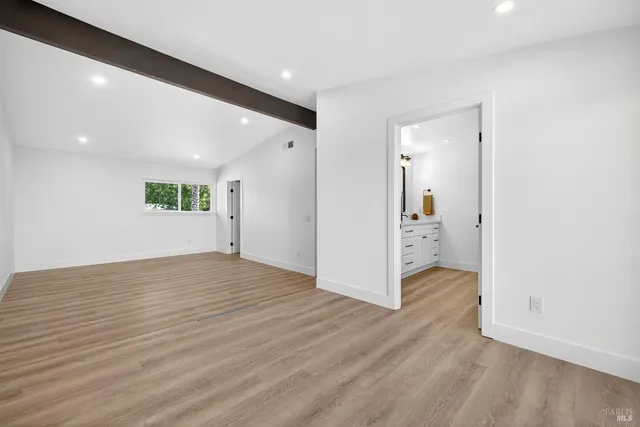a view of a brick house with a yard and plants next to road