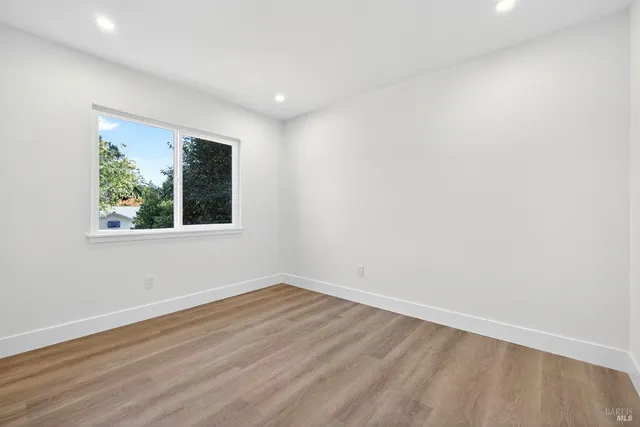 a wooden bench sitting in the middle of a yard