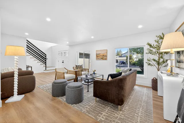 a living room with furniture and a wooden floor