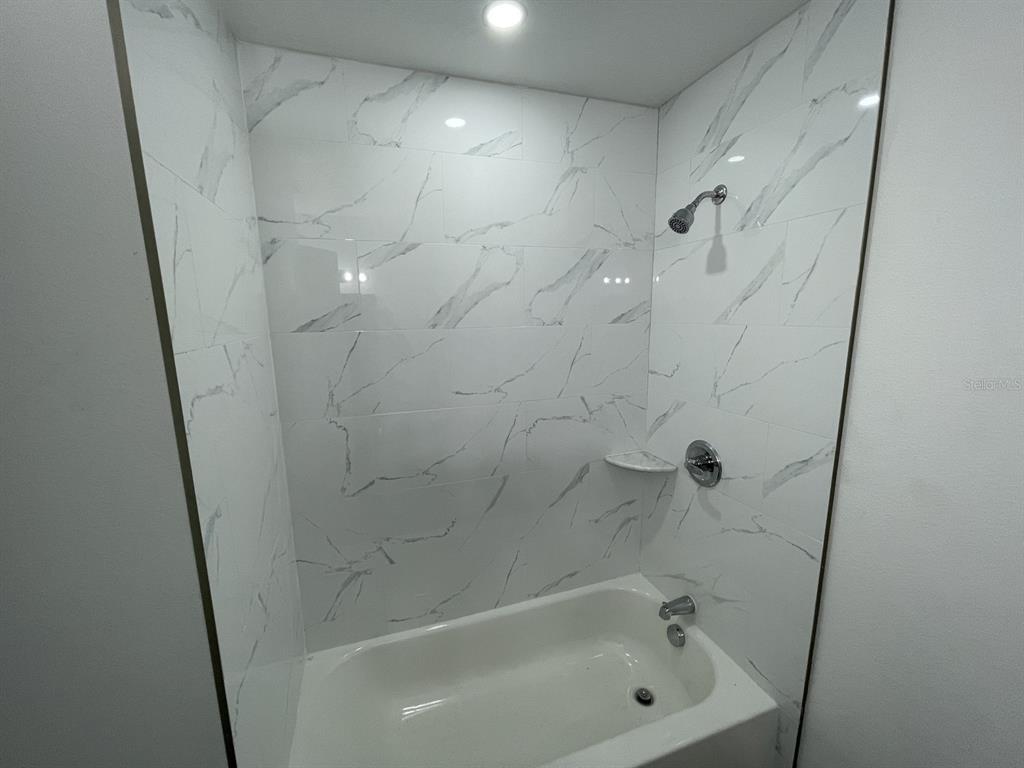 9835 Gray Fox Lane Port Richey, FL 34668 - Photo 13 of 17 a bathroom with a bathtub