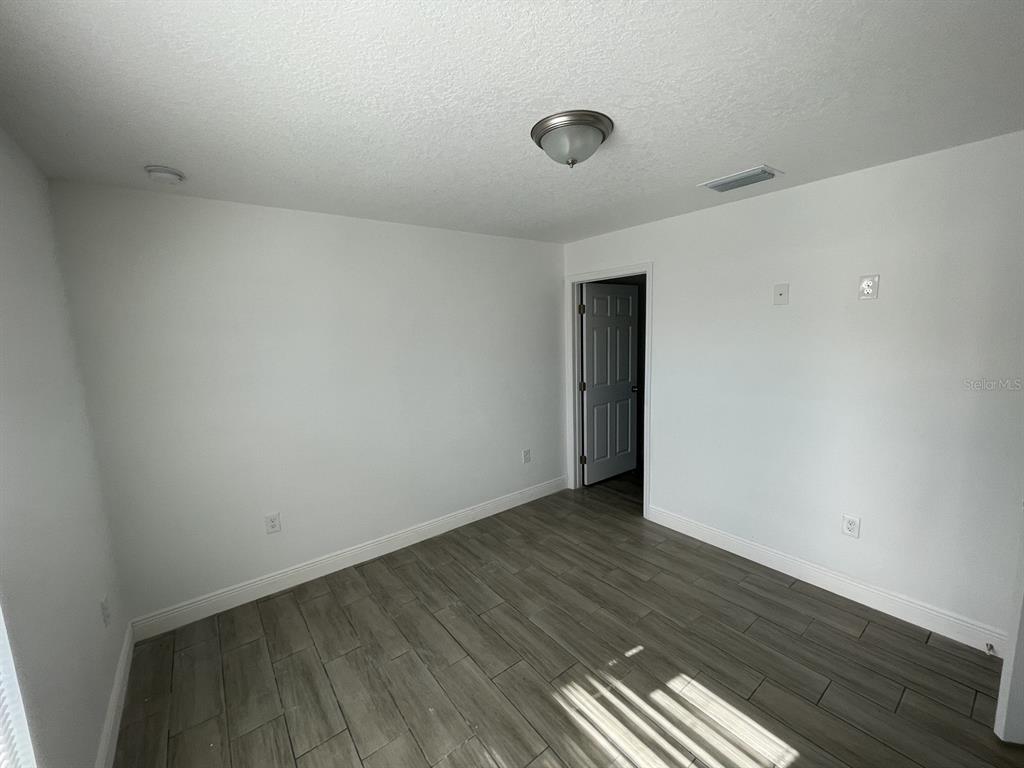 9835 Gray Fox Lane Port Richey, FL 34668 - Photo 15 of 17 a view of an empty room with wooden floor