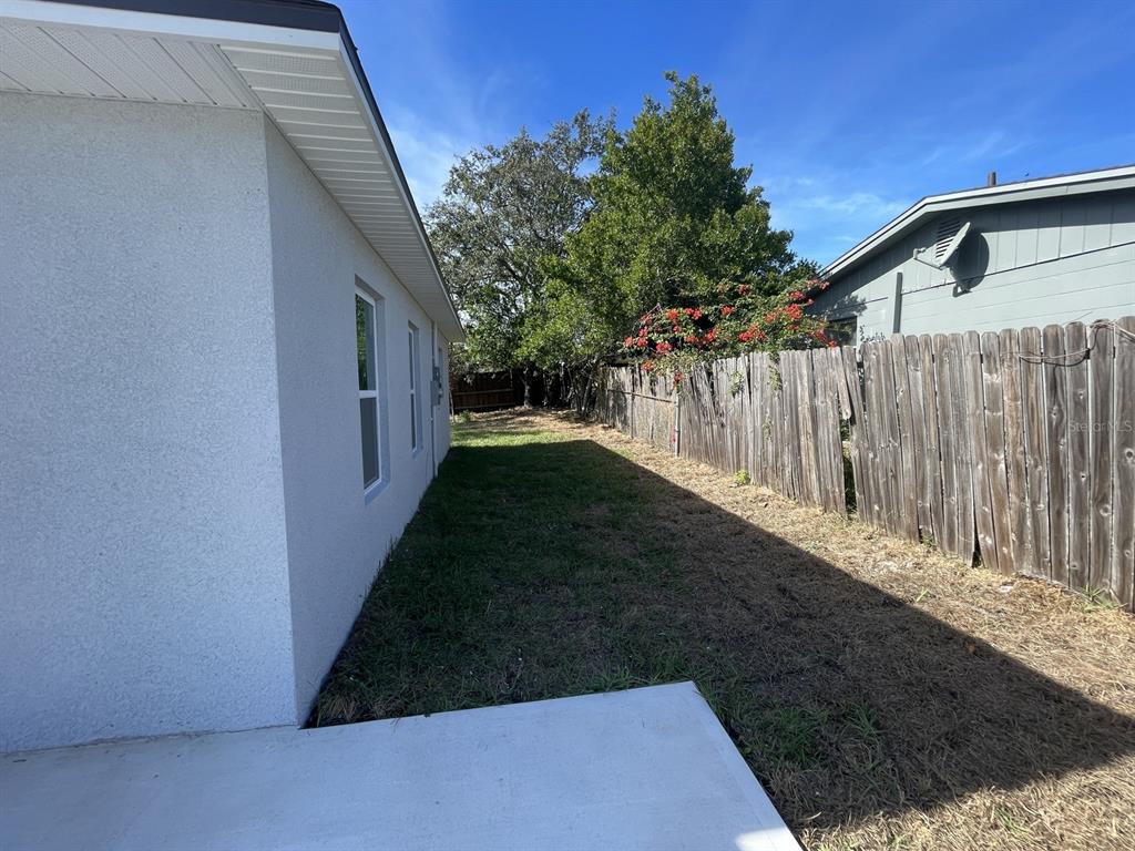 9835 Gray Fox Lane Port Richey, FL 34668 - Photo 5 of 17 a view of a backyard with pathway