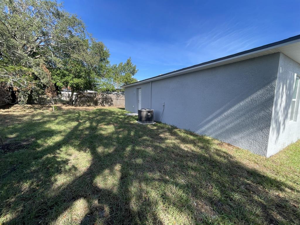 9835 Gray Fox Lane Port Richey, FL 34668 - Photo 10 of 17 a backyard of a house with lots of green space