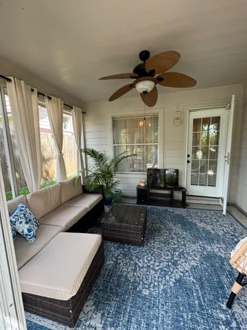 a living room with furniture and a large window