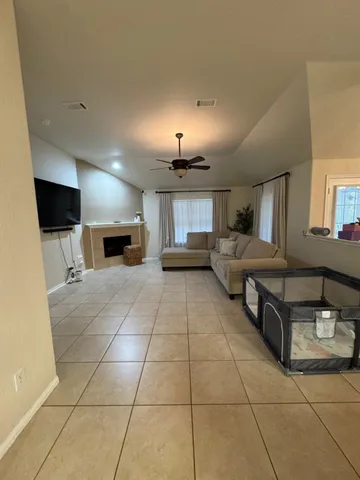 a large room with a large window and furniture