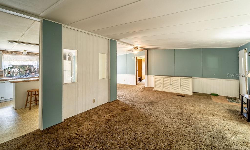 24031 Armadillo Road Astor, FL 32102 - Photo 8 of 43 a view of a big room with closet and wooden floor