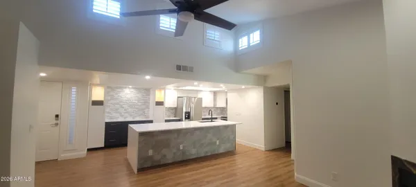a kitchen with kitchen island a sink stainless steel appliances and cabinets
