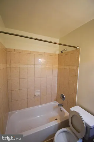 a bathroom with a shower and a toilet