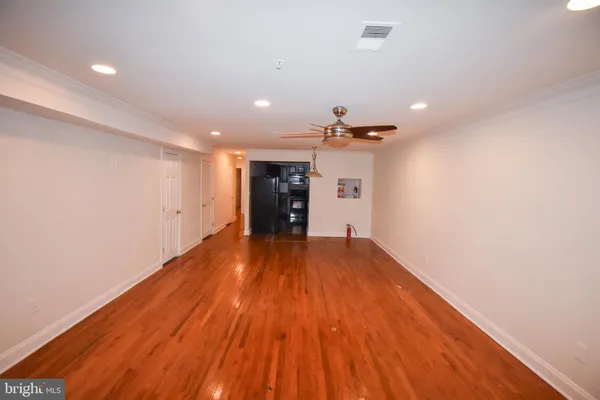 a view of a room with wooden floor